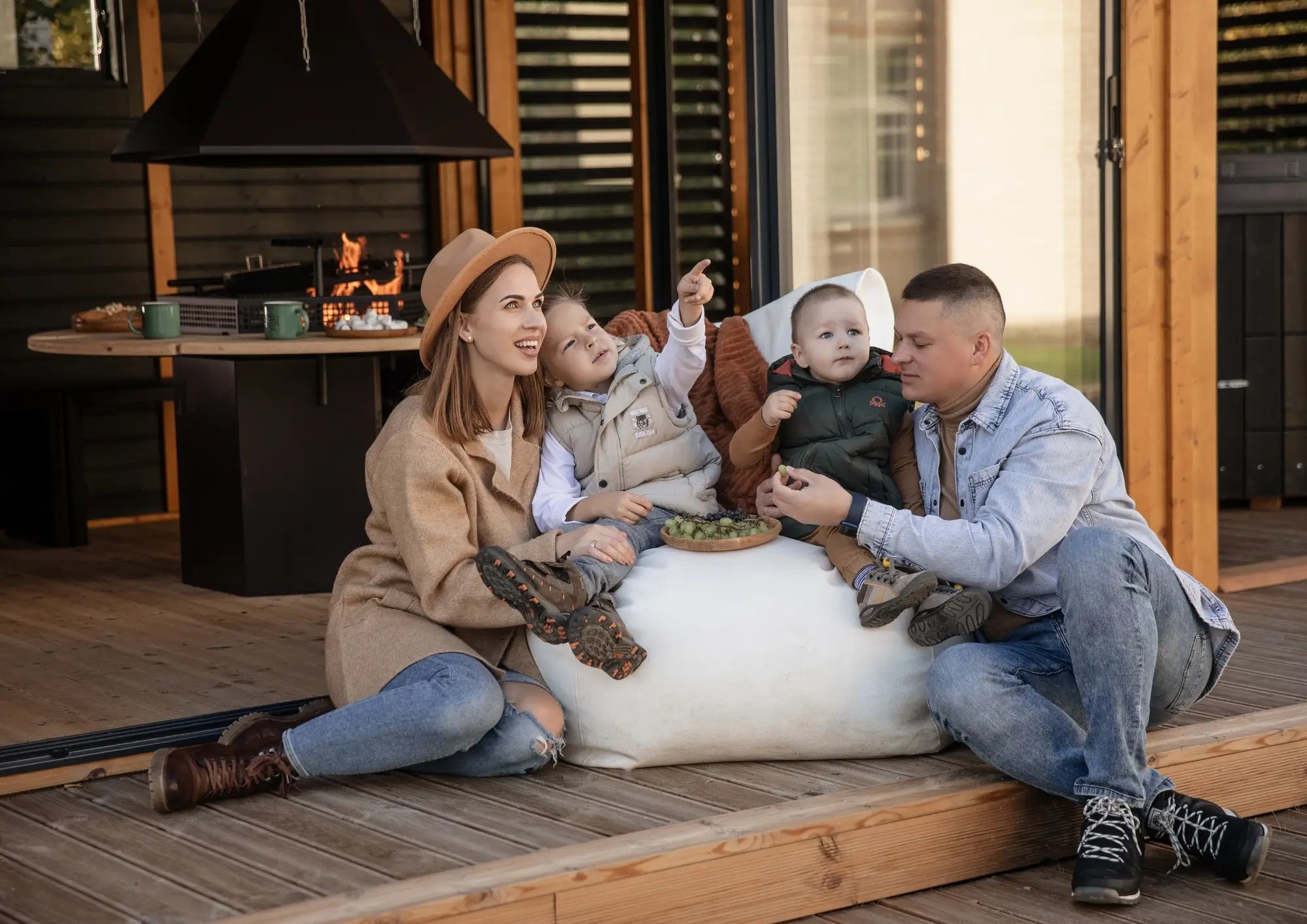 Family relaxing outside a hospitality pod with covered outdoor seating and social space.