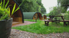Drone view of three glamping pods at The Crown at Pantygelli, overlooking the Brecon Beacons countryside.