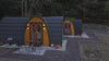 Drone flyout video of two completed glamping pods at Doune House Pods in Scotland, starting with a close aerial view of the accommodation before pulling back to reveal the wider site and surrounding woodland.