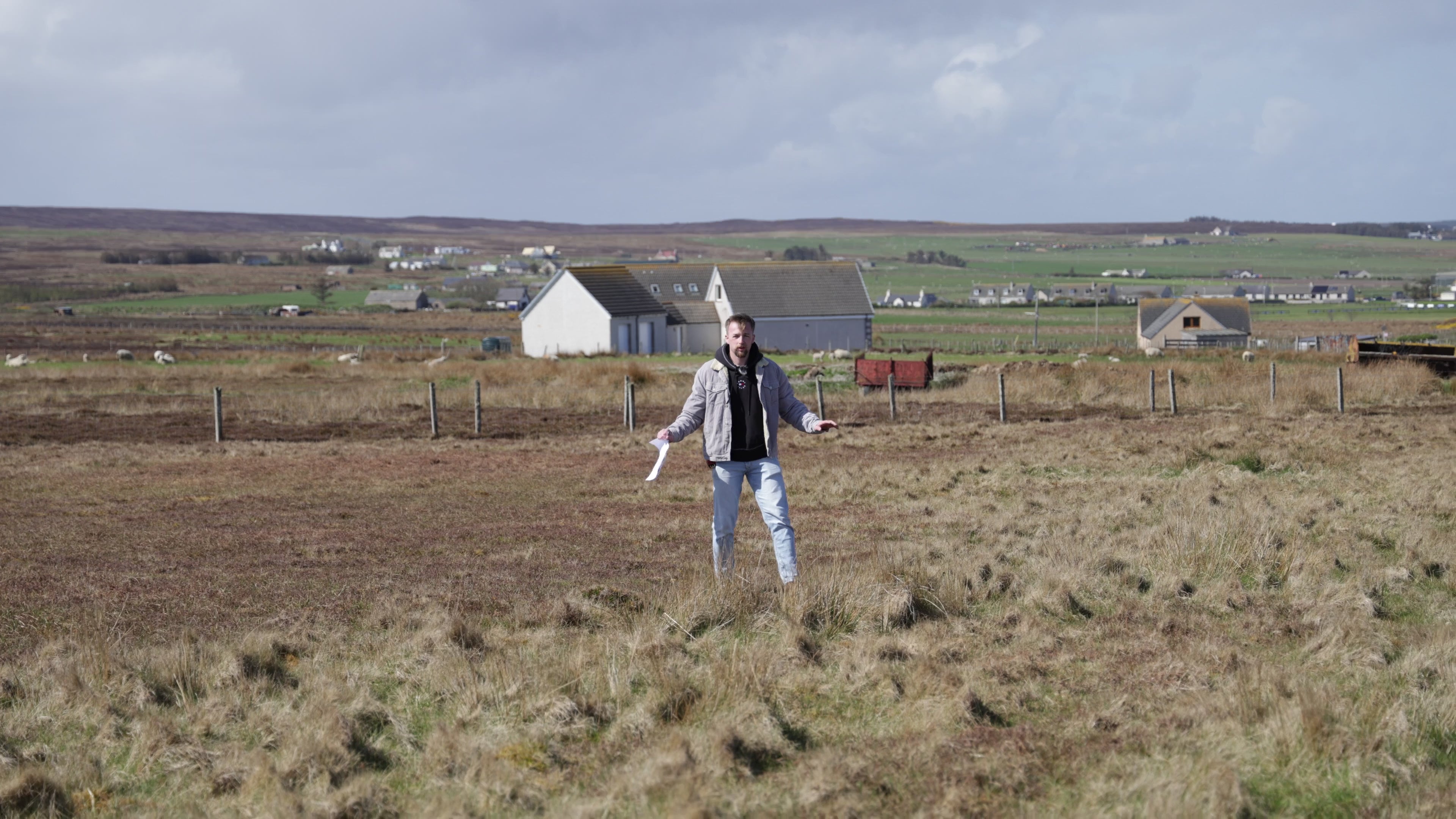 Taylor Glass walking a prospective development site with project drawings, explaining access routes, site planning considerations, and the early stages of creating a future glamping and hospitality development.