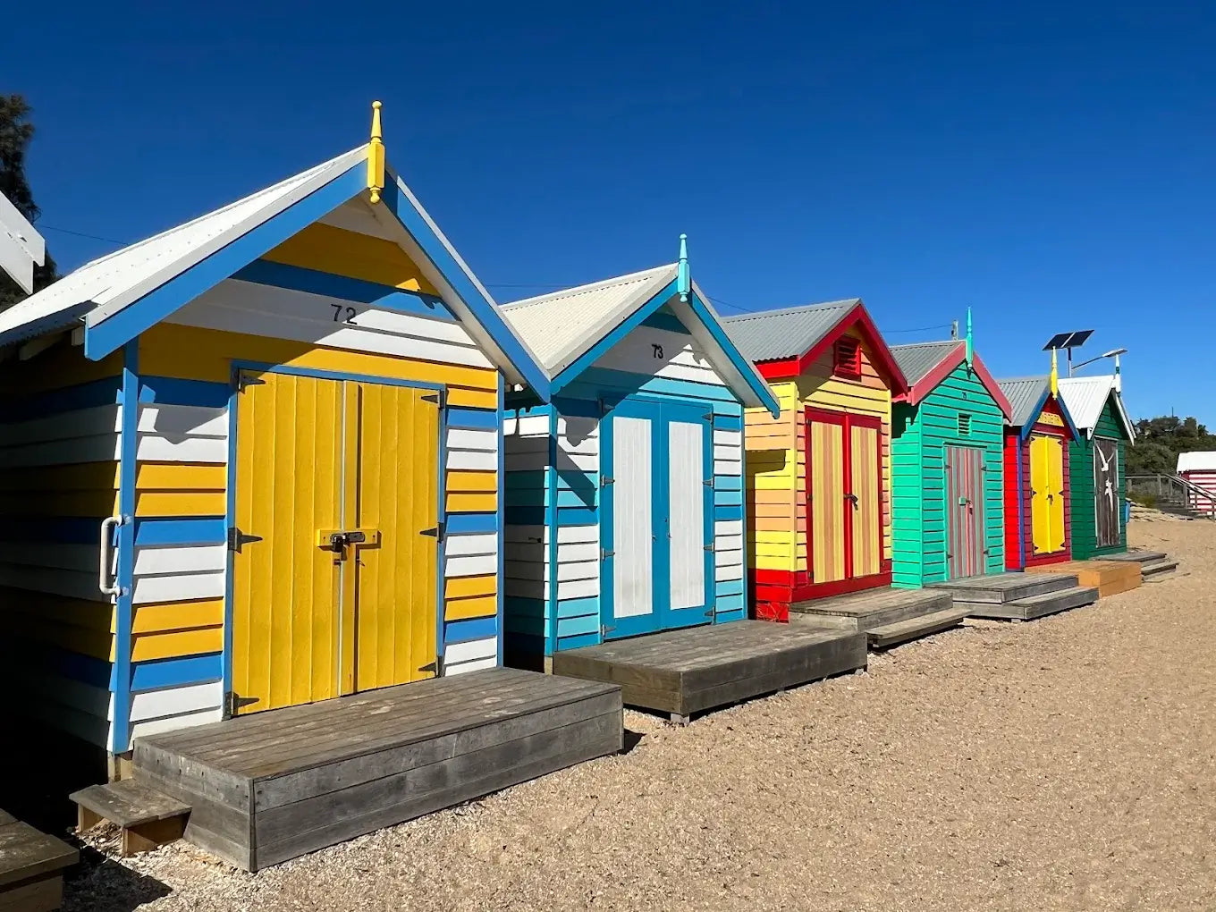 Colorful modular beach huts installed on public land, representing flexible pod infrastructure for local councils, tourism boards, and government initiatives.