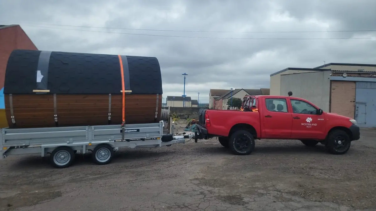 Mobile barrel sauna on a trailer for beach, lakeside and outdoor wellness use